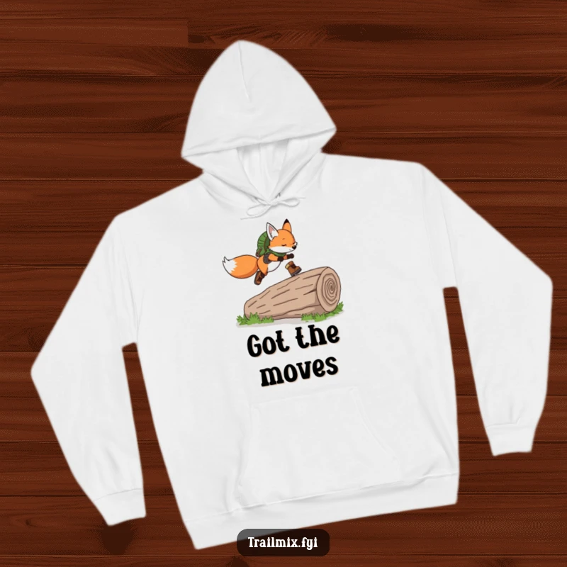Funny Fox Hoodie: Soft hoodie featuring a playful fox wearing hiking boots, gracefully leaping over a fallen log, full of spirit.