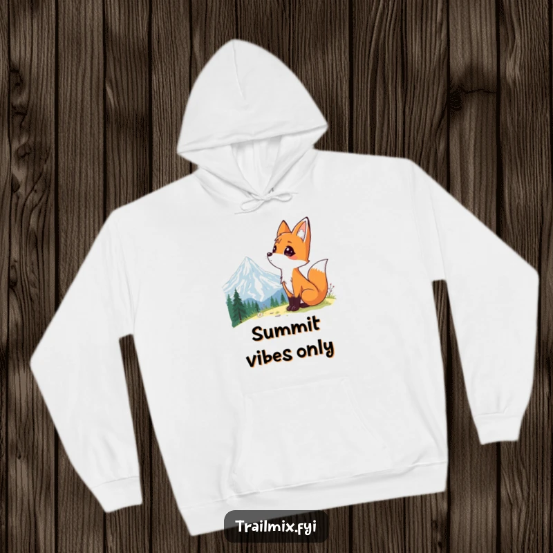 Funny hoodie displaying a curious fox with eyes wide, looking at a grand mountain landscape, capturing a moment of pure awe.