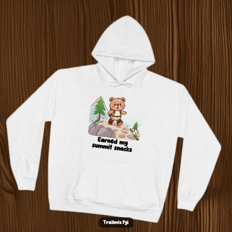 Funny hoodie featuring a fuzzy bear wearing hiking boots, joyfully skipping up a mountain path, designed for warmth and laughter.