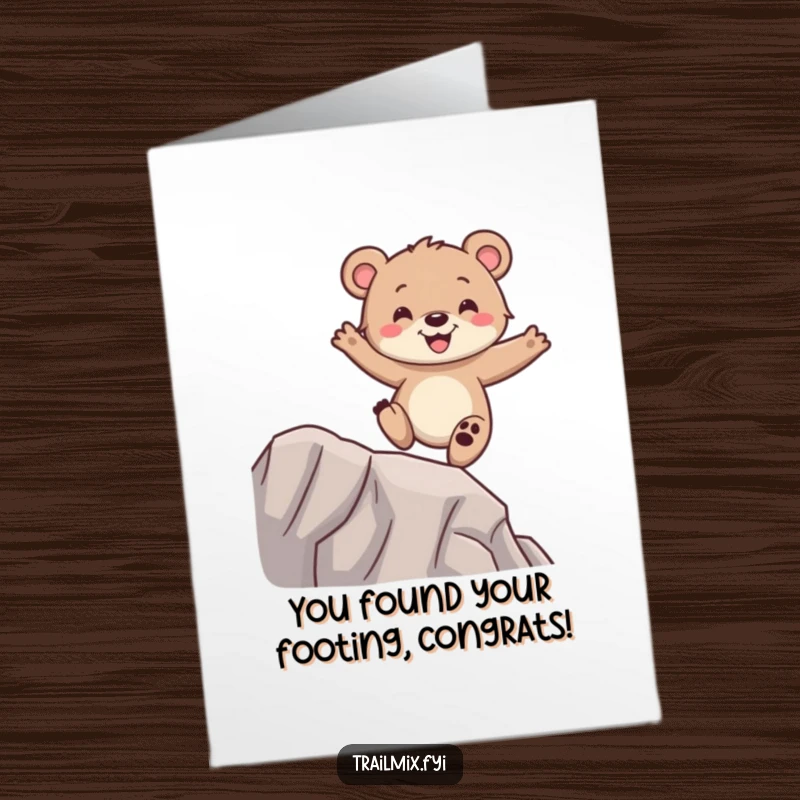 Funny Free Printable congratulations card showing a happy bear cub balancing with glee on a narrow ridge, celebrating success, downloadable gift.